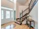 Elegant foyer featuring hardwood floors, staircase with iron railings, and a decorative front door at 1756 Indigo Island Dr, Hanahan, SC 29410