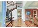 Elegant foyer with hardwood floors, ornate staircase, and a view into the dining and living spaces at 1756 Indigo Island Dr, Hanahan, SC 29410