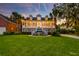 Attractive home with a sprawling porch, well-manicured lawn, and tropical palm trees at 1756 Indigo Island Dr, Hanahan, SC 29410