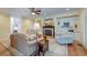 Open-concept living room with a fireplace and built-in shelving for storage and display at 1756 Indigo Island Dr, Hanahan, SC 29410