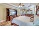 Spacious primary bedroom featuring a large bed, dresser, TV, and an ensuite bathroom with a double vanity at 1756 Indigo Island Dr, Hanahan, SC 29410