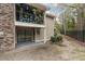 View of a patio beneath a balcony, adorned with potted plants and surrounded by a black iron fence at 1860 Montclair Dr # 1860-A, Mount Pleasant, SC 29464