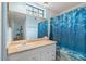Bright bathroom featuring a large mirror, vanity, and a shower with a blue curtain at 1860 Montclair Dr # 1860-A, Mount Pleasant, SC 29464