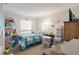 Comfortable bedroom with blue bedding, shelving, and natural light at 1860 Montclair Dr # 1860-A, Mount Pleasant, SC 29464