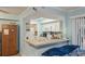 Bright kitchen with white cabinetry and a functional pass-through bar connecting to a nearby living space at 1860 Montclair Dr # 1860-A, Mount Pleasant, SC 29464