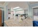 Bright kitchen features granite countertops, white cabinets, and modern appliances under a skylight at 1860 Montclair Dr # 1860-A, Mount Pleasant, SC 29464