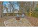 Inviting backyard with a stone fire pit, Adirondack chairs, and a wooden privacy fence at 2005 Carriage Way, Summerville, SC 29485