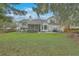 Picturesque backyard with a covered patio, barbecue area, and plenty of green space for entertaining at 2005 Carriage Way, Summerville, SC 29485