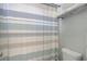 Clean bathroom featuring a toilet with a striped shower curtain and towel rack at 2005 Carriage Way, Summerville, SC 29485