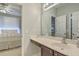 This beautiful bathroom features a large mirror, vanity with sink, and doorway to the bedroom at 2005 Carriage Way, Summerville, SC 29485