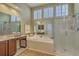 Bright bathroom with a large soaking tub, vanity with cabinetry, and a modern shower at 2005 Carriage Way, Summerville, SC 29485