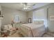 This cozy bedroom has a white metal bed frame, writing desk, and sitting area at 2005 Carriage Way, Summerville, SC 29485
