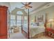 This primary bedroom features vaulted ceilings, a four-poster bed, and large windows to let in plenty of light at 2005 Carriage Way, Summerville, SC 29485