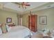 Inviting bedroom with a tray ceiling, four post bed, and a traditional armoire at 2005 Carriage Way, Summerville, SC 29485