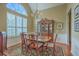 This stylish dining room features lots of natural light and ornate, wooden furniture at 2005 Carriage Way, Summerville, SC 29485