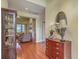 This bright entryway includes hardwood floors, a dresser, and a glimpse into the living room at 2005 Carriage Way, Summerville, SC 29485