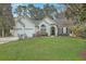 Charming single-story home featuring a two-car garage, a well-maintained lawn, and classic curb appeal at 2005 Carriage Way, Summerville, SC 29485