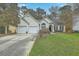Attractive single-Gathering home with a neatly maintained lawn, attached garage, and inviting curb appeal at 2005 Carriage Way, Summerville, SC 29485