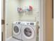 This practical laundry room has a washer and dryer and shelving for cleaning supplies at 2005 Carriage Way, Summerville, SC 29485