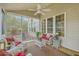 Relaxing screened porch with white wicker furniture, ceiling fan, and views of the backyard at 2005 Carriage Way, Summerville, SC 29485