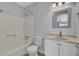 This bathroom offers a tub shower combo, toilet, vanity with mirror, and neutral paint at 208 Greencastle Dr, Goose Creek, SC 29445