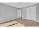 The bedroom features wood floors, a ceiling fan, a closet, and neutral paint at 208 Greencastle Dr, Goose Creek, SC 29445