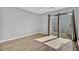 Bedroom features hardwood floors, large windows with curtains, and neutral paint at 208 Greencastle Dr, Goose Creek, SC 29445