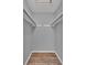 A walk-in closet features two long white shelves, grey walls, and laminate flooring at 208 Greencastle Dr, Goose Creek, SC 29445