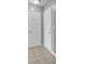 Entryway features neutral flooring, a ceiling light, light grey walls, and two white doors at 208 Greencastle Dr, Goose Creek, SC 29445