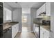 Well-lit kitchen featuring white cabinetry, stainless steel appliances, and modern backsplash at 208 Greencastle Dr, Goose Creek, SC 29445
