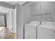 Laundry room features a white washer and dryer and wire shelving for storage space at 208 Greencastle Dr, Goose Creek, SC 29445