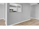 Gray living room showing view of kitchen and hallway through connecting interior windows at 208 Greencastle Dr, Goose Creek, SC 29445