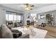 Comfortable living room featuring a fireplace, ceiling fan, and sliding doors to the screened-in patio at 208 Greencastle Dr, Goose Creek, SC 29445