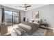 Bright main bedroom with sliding glass doors to balcony, modern ceiling fan, and clean interior design at 208 Greencastle Dr, Goose Creek, SC 29445