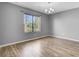 Bright room with large window and modern light fixture, offers serene nature views at 208 Greencastle Dr, Goose Creek, SC 29445