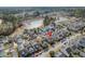 An aerial view of a residential neighborhood showcasing the proximity to a tranquil lake and community amenities at 213 Crossandra Ave, Summerville, SC 29483