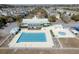 Aerial view of a community pool area including a large pool, clubhouse, and a splash pad at 213 Crossandra Ave, Summerville, SC 29483