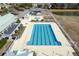 Overhead shot of a community swimming pool offering clear blue water, surrounded by lounging areas and landscaping at 213 Crossandra Ave, Summerville, SC 29483