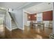 Open-concept dining room with hardwood floors, adjacent to a staircase and living area at 213 Crossandra Ave, Summerville, SC 29483