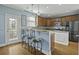 Stylish kitchen featuring a breakfast bar, granite countertops, stainless steel appliances, and a cozy eat-in area at 213 Crossandra Ave, Summerville, SC 29483