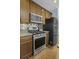 Functional kitchen featuring granite countertops, stainless steel gas range, and stainless steel microwave and refrigerator at 213 Crossandra Ave, Summerville, SC 29483