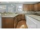 Open kitchen with granite countertops, stainless steel appliances, and wooden cabinets, seamlessly connecting style and functionality at 213 Crossandra Ave, Summerville, SC 29483