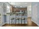 Stylish kitchen with breakfast bar seating, granite countertops, stainless steel appliances, and easy access to other living areas at 213 Crossandra Ave, Summerville, SC 29483