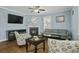 Charming living room featuring hardwood floors, a cozy fireplace, and comfortable seating, creating a welcoming atmosphere at 213 Crossandra Ave, Summerville, SC 29483
