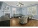 Inviting living room with a fireplace, hardwood floors, and ample natural light, perfect for relaxation and gatherings at 213 Crossandra Ave, Summerville, SC 29483