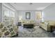 Bright living room with large windows, comfortable seating, and neutral decor at 213 Crossandra Ave, Summerville, SC 29483