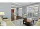Inviting living room with hardwood floors, a view to the dining room, and ample natural light at 213 Crossandra Ave, Summerville, SC 29483