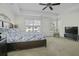 Bright bedroom with tray ceiling, ceiling fan, plush carpet, and views of the neighborhood at 213 Crossandra Ave, Summerville, SC 29483