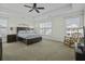 Spacious bedroom with a tray ceiling, ceiling fan, carpet, and plenty of natural light at 213 Crossandra Ave, Summerville, SC 29483