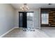 Bright dining area with a modern chandelier, sliding glass door to the backyard, and a wood accent wall at 240 Island Green Rd, Goose Creek, SC 29445